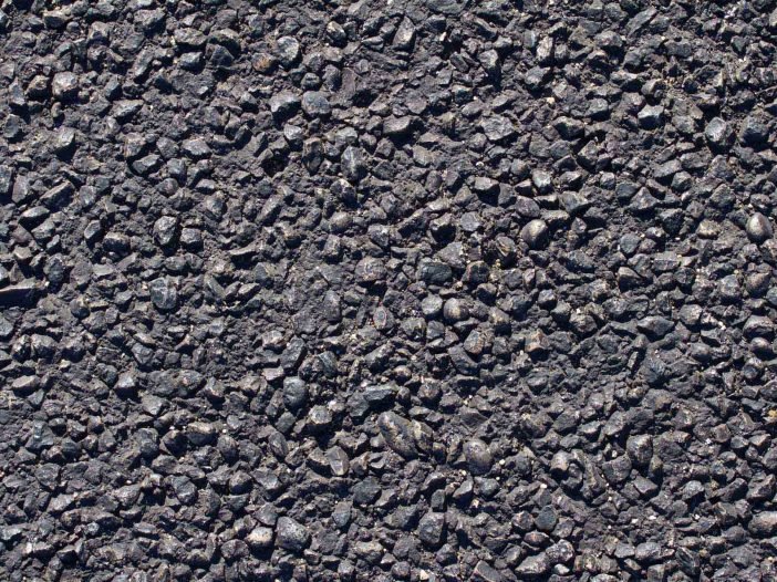 Close-up of compacted hot-mix asphalt surface on a residential driveway