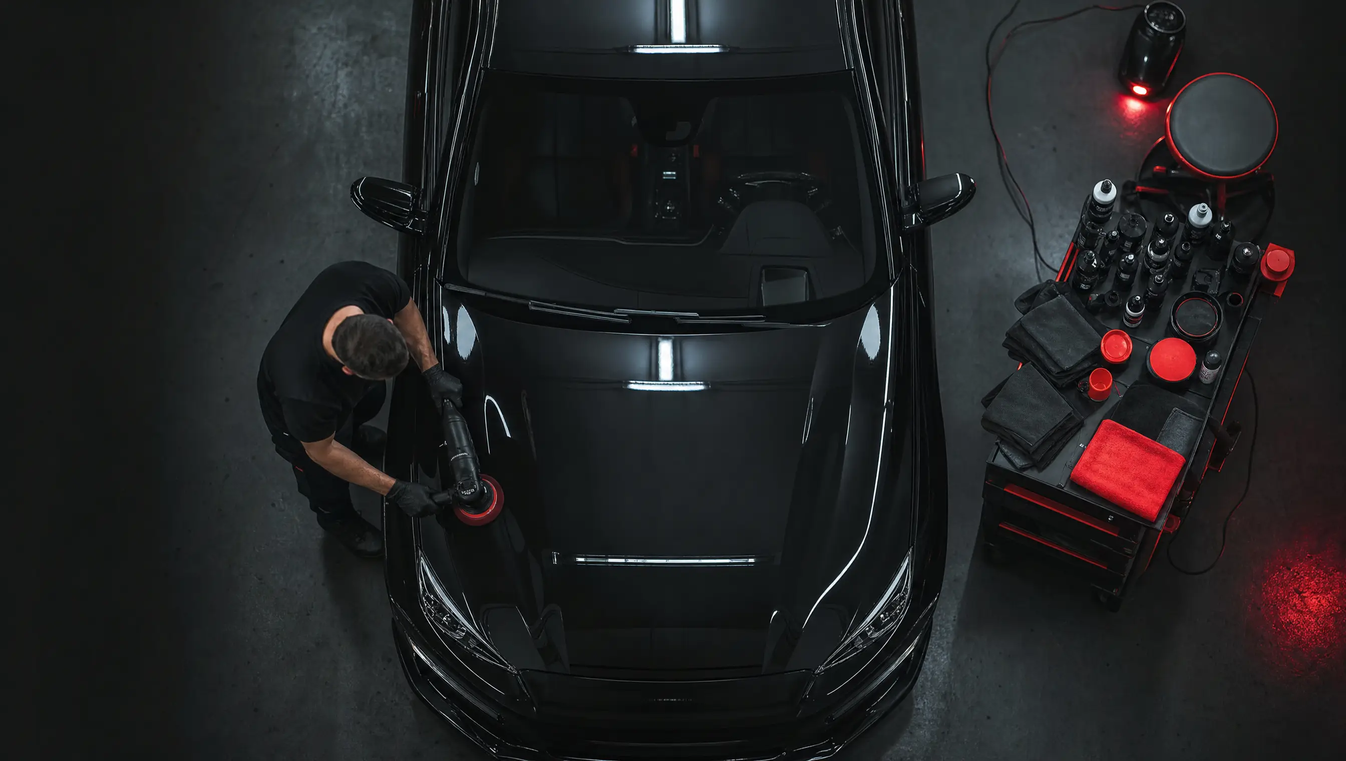 Professional detailing bay during a paint correction and coating job